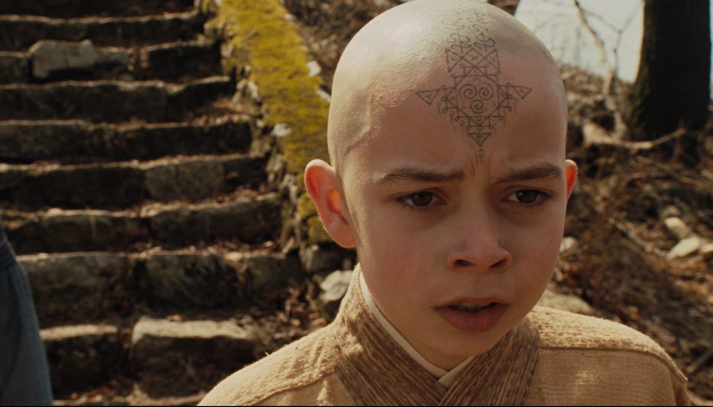 Aang has a saddened look on his face.