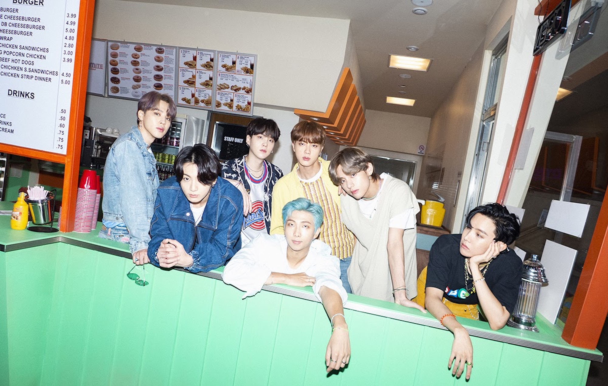 BTS posing inside of a fast food restaurant. 