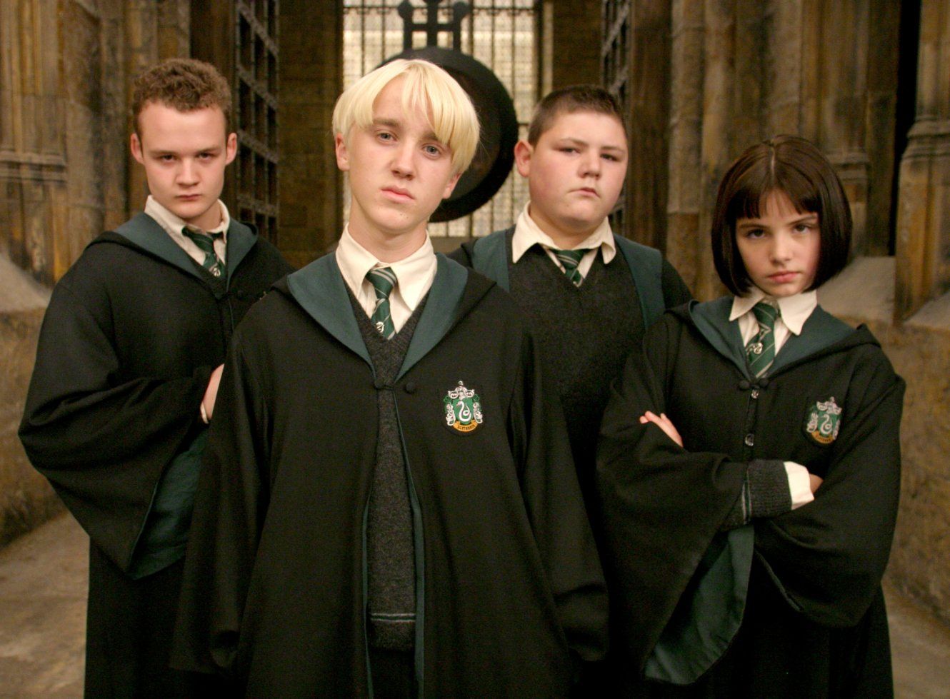 Draco Malfoy, Vincent Crabbe, Gregory Goyle, and Pansy Parkinson stare threateningly into the camera.