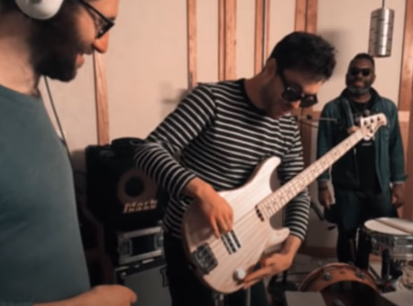 Joe Dart demonstrates the volume knob on the Joe Dart Signature Bass while Jack Stratton looks on. 