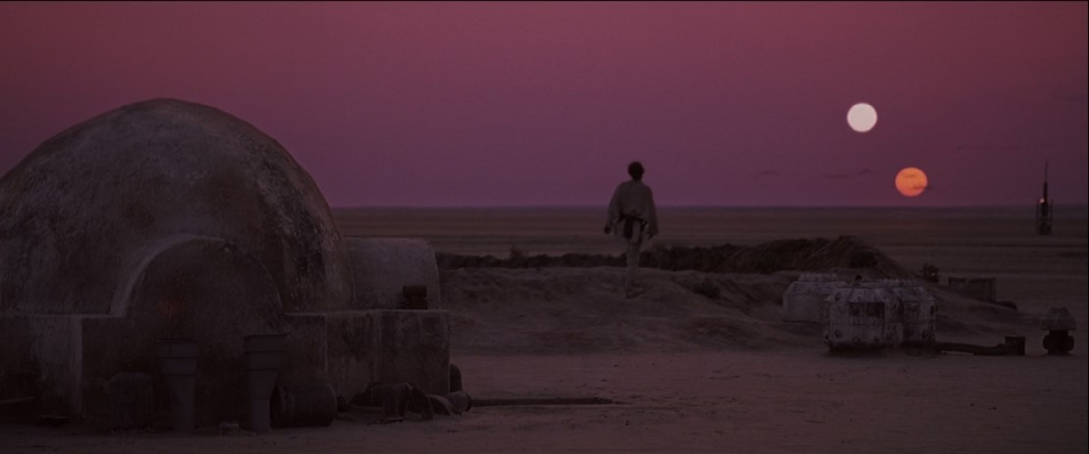 Luke Skywalker stares at the binary sunset in Star Wars: A New Hope.