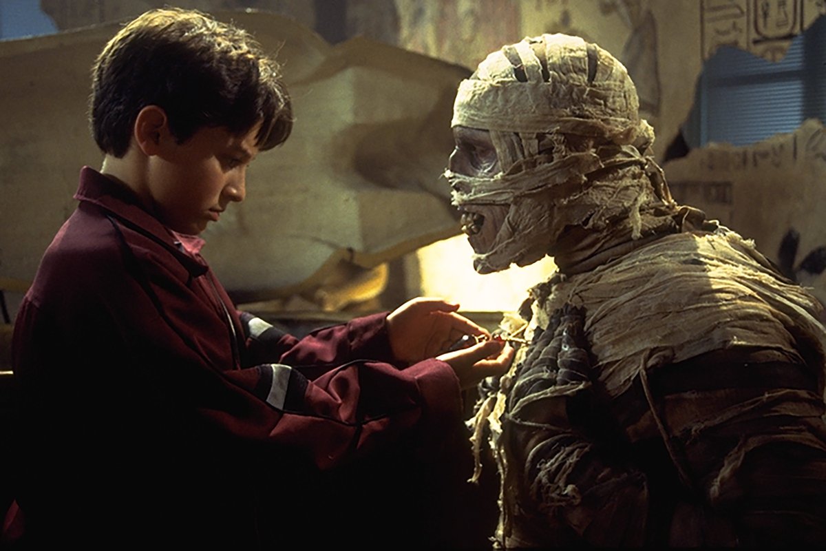 Marshall looks at the mummy's amulet. 