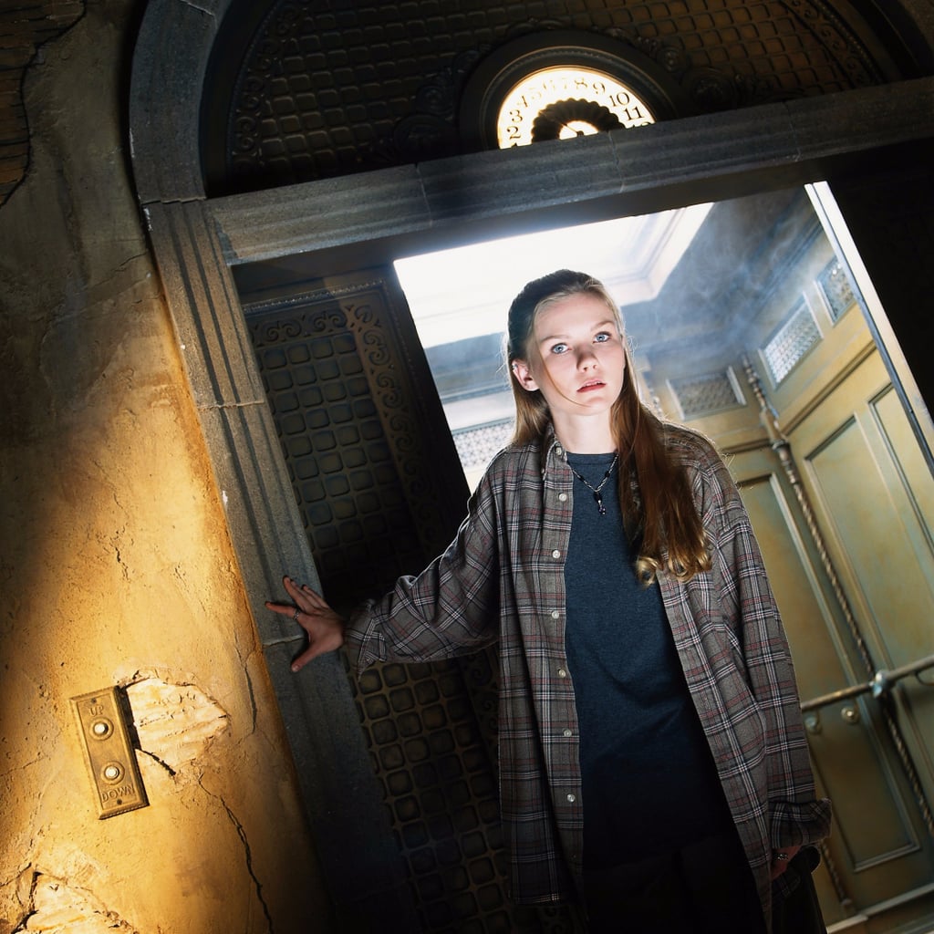 Kirsten Dunst standing in front of the elevator on the set of Disney's Tower of Terror. 