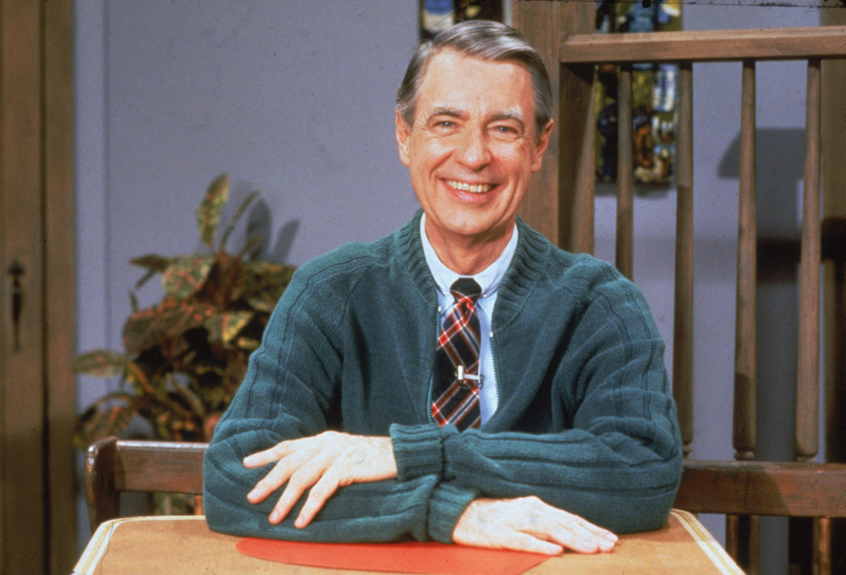 Mister Rogers in a sweater smiling