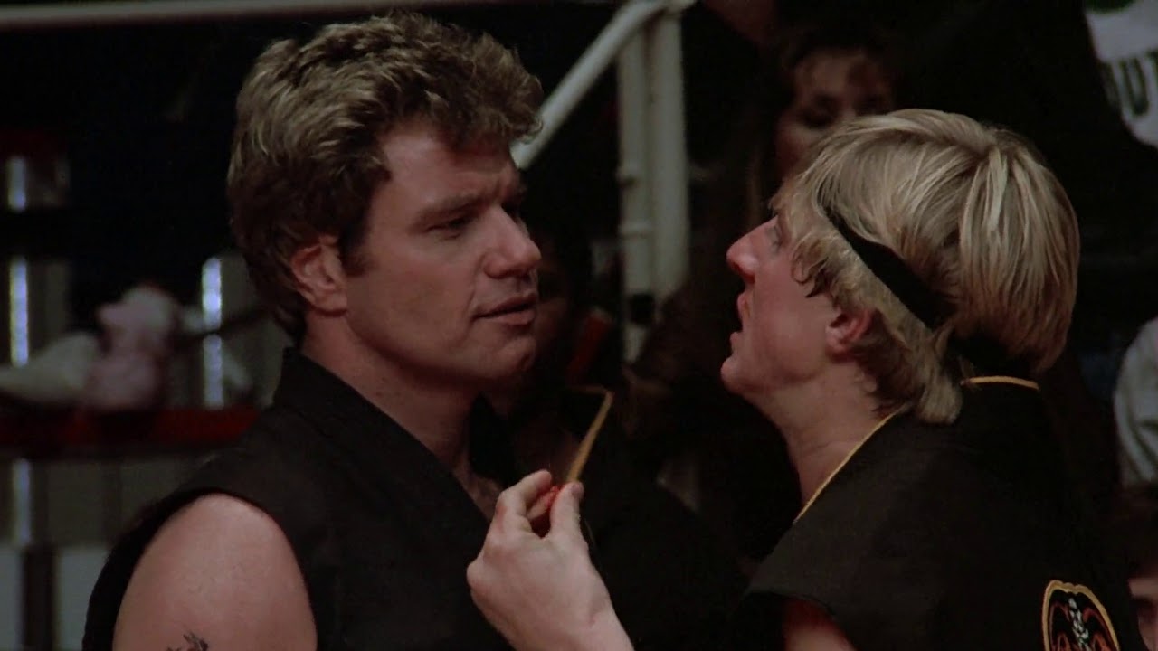 John Kreese tells a young Johnny Lawrence to sweep the leg on Daniel.