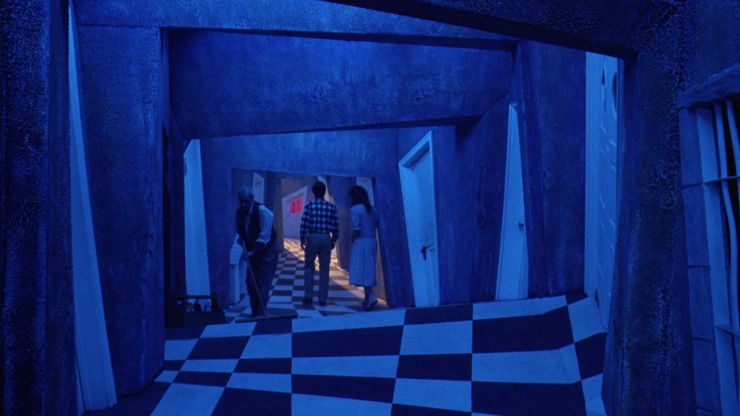 Barbra and Adam in the afterlife with strange but unique hallway designs in the film Beetlejuice.  