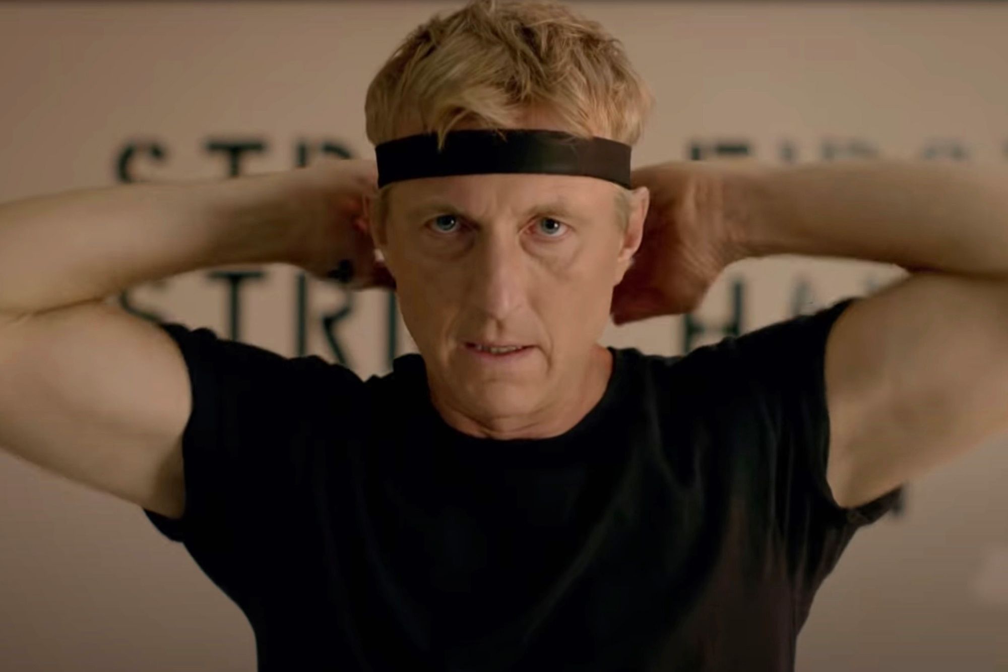 Johnny Lawrence fastens his trademark black headband around his forehead.