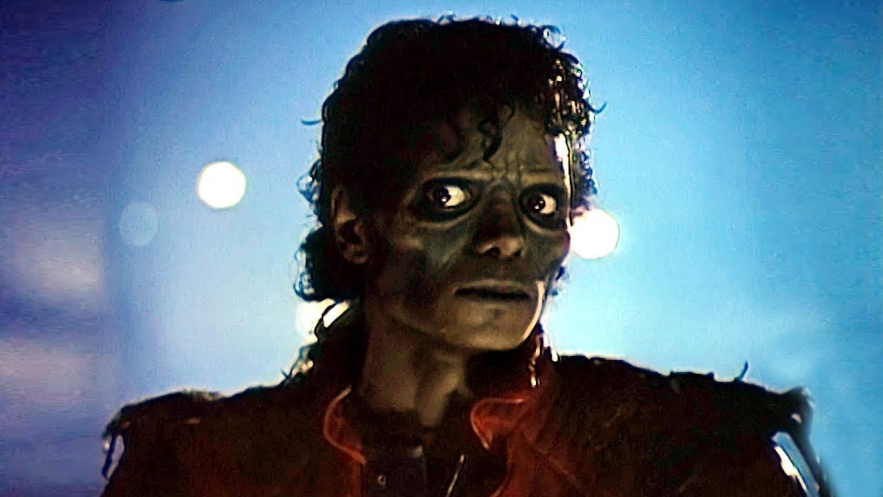 Michael Jackson stares past the camera in full zombie makeup in the Thriller music video, often considered a staple of Halloween music.