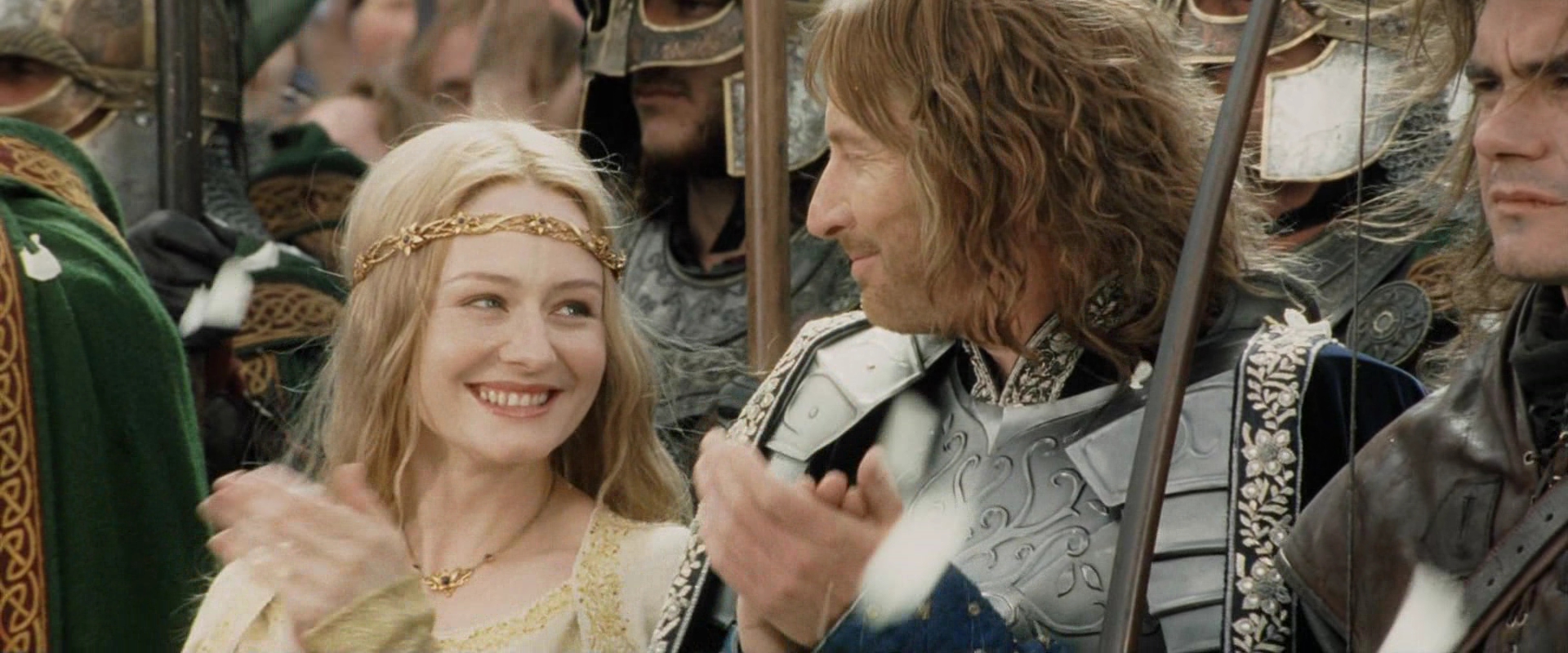 Eowyn and Faramir stand together at Aragorn's coronation.