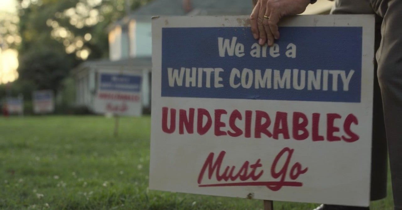 A white man puts a sign in his yard that reads, "We are a white community. Undesirables must go."