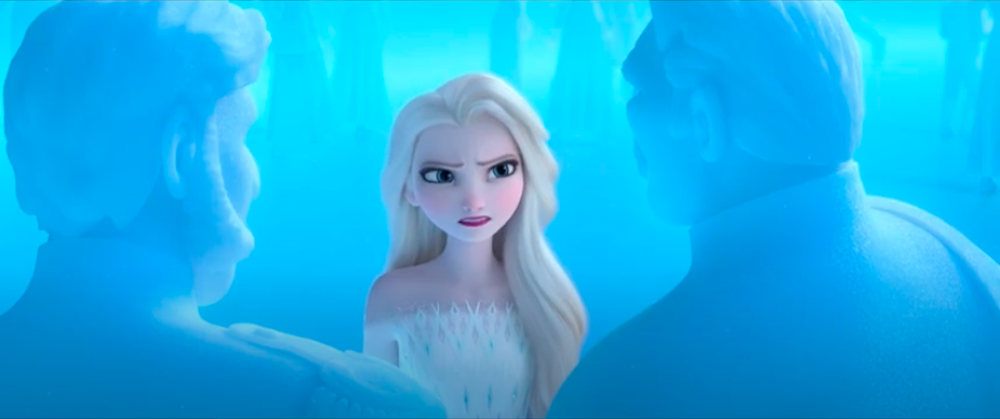 Elsa glares at the ice memory of her grandfather, King Runeard, as he explains his plan to betray the Northuldra in Disney's Frozen II.