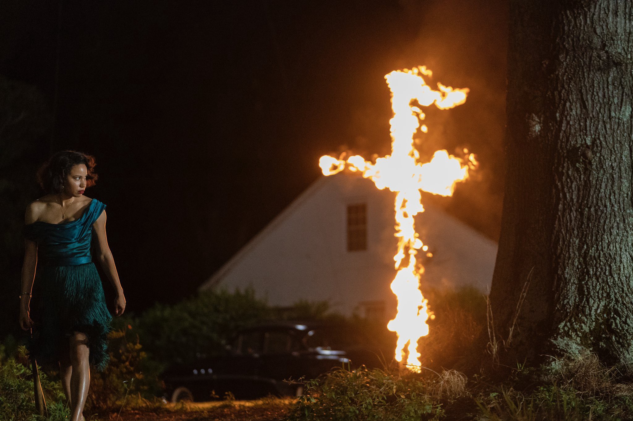 Leti grabs a bat after racist neighbors burn a cross on her lawn.