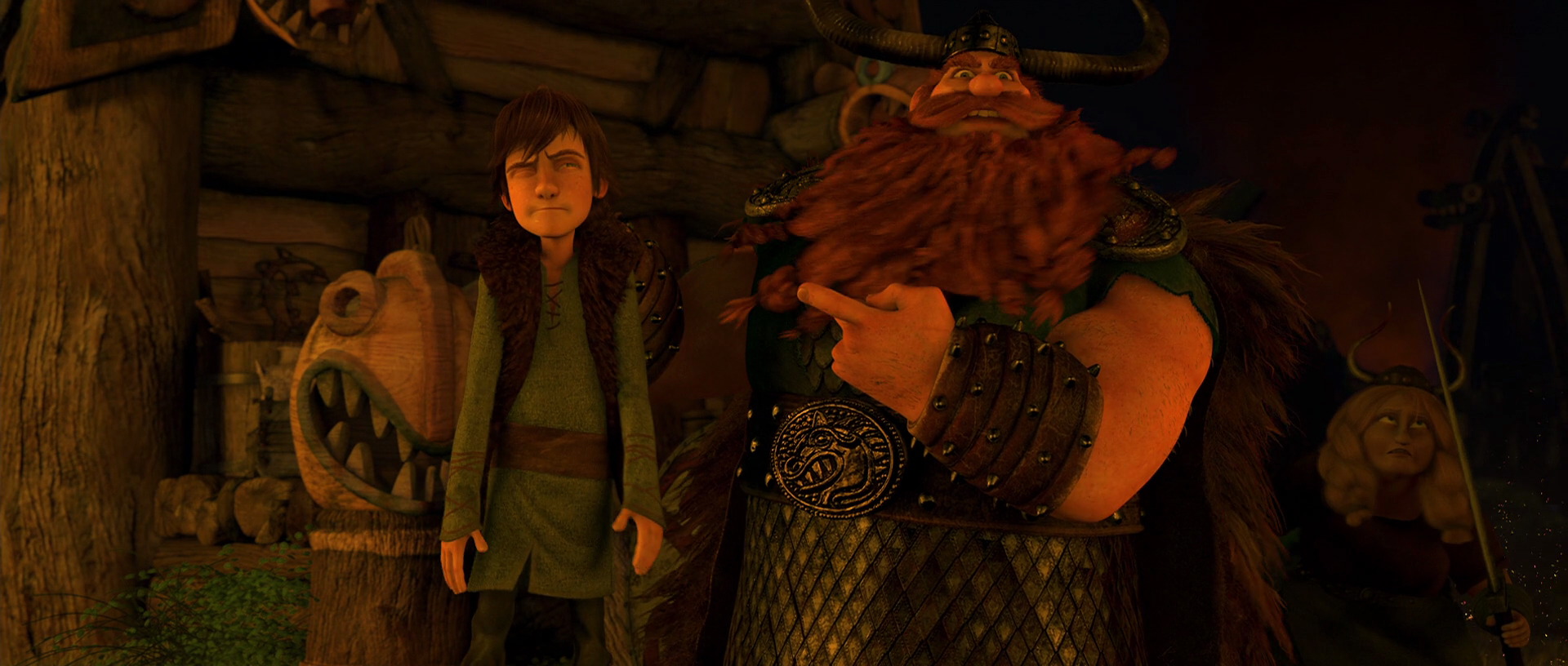 During a nighttime dragon battle, Stoick points to Hiccup and tells him to get back inside.