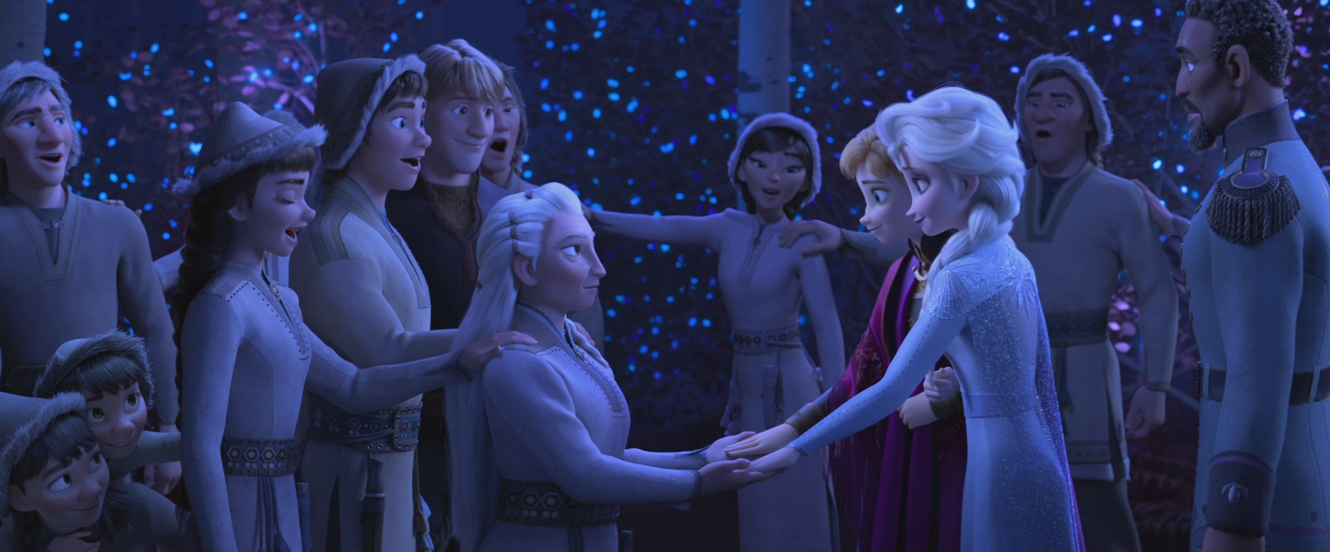 Anna and Elsa join hands with Yelena in the middle of a circle of singing Northuldra people.