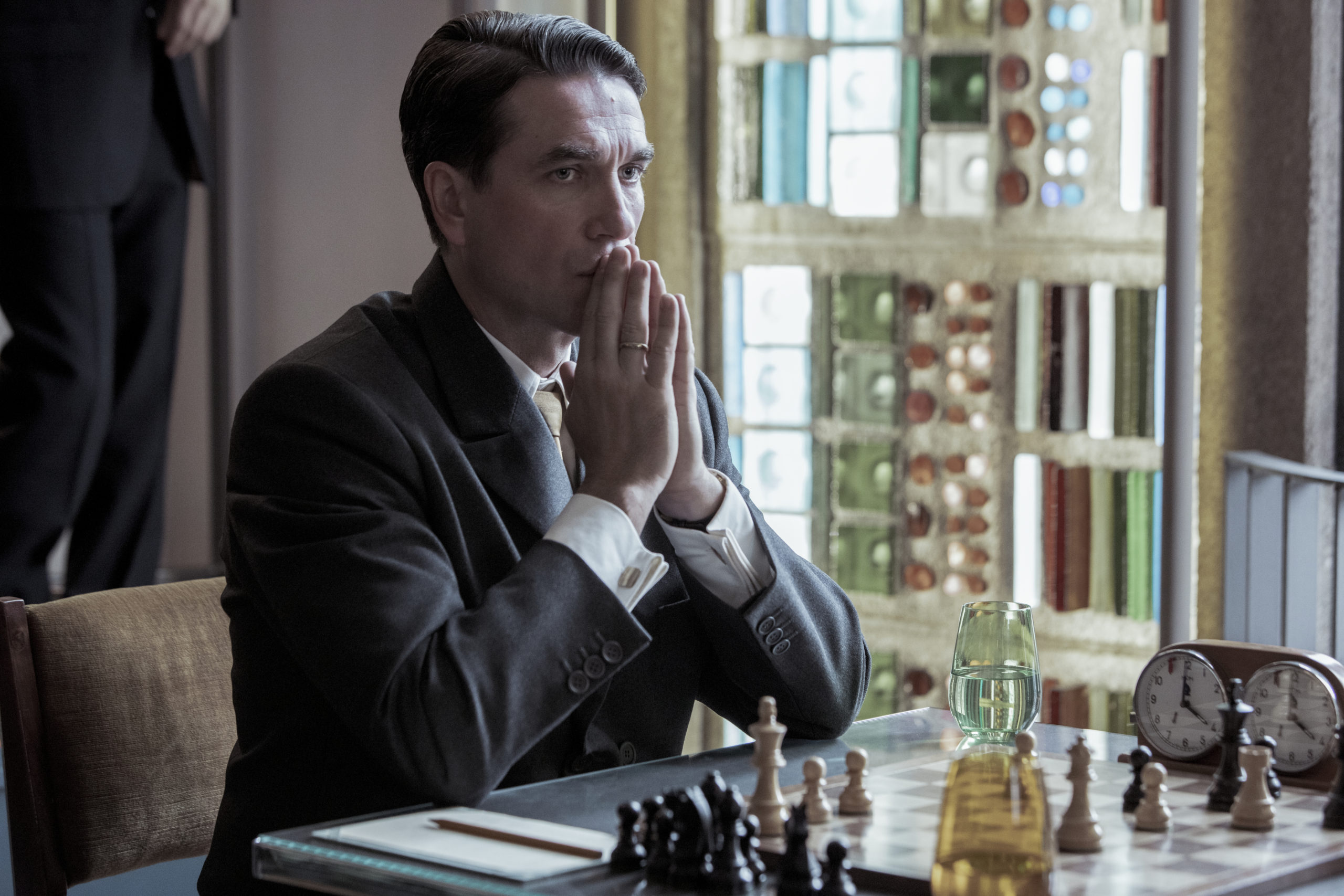 Vasily Borgov (Marcin Dorociński) sits at the chess board awaiting the arrival of Beth Harmon, his formidable opponent.