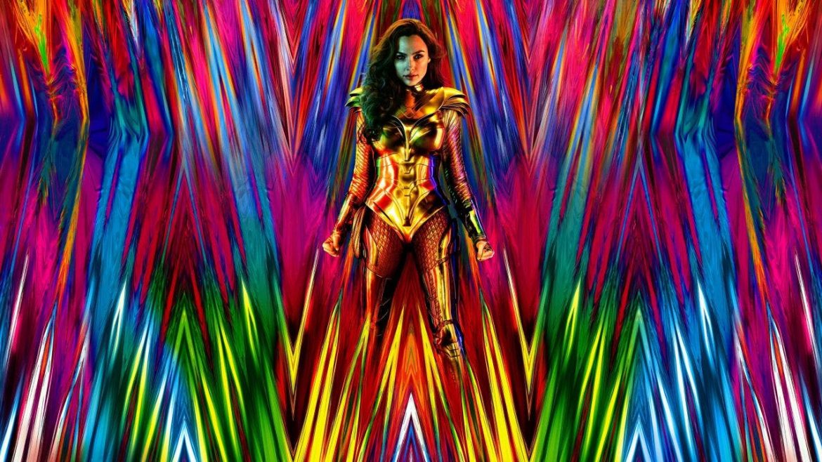 Wonder Woman stands in the middle of a colorful prism background.