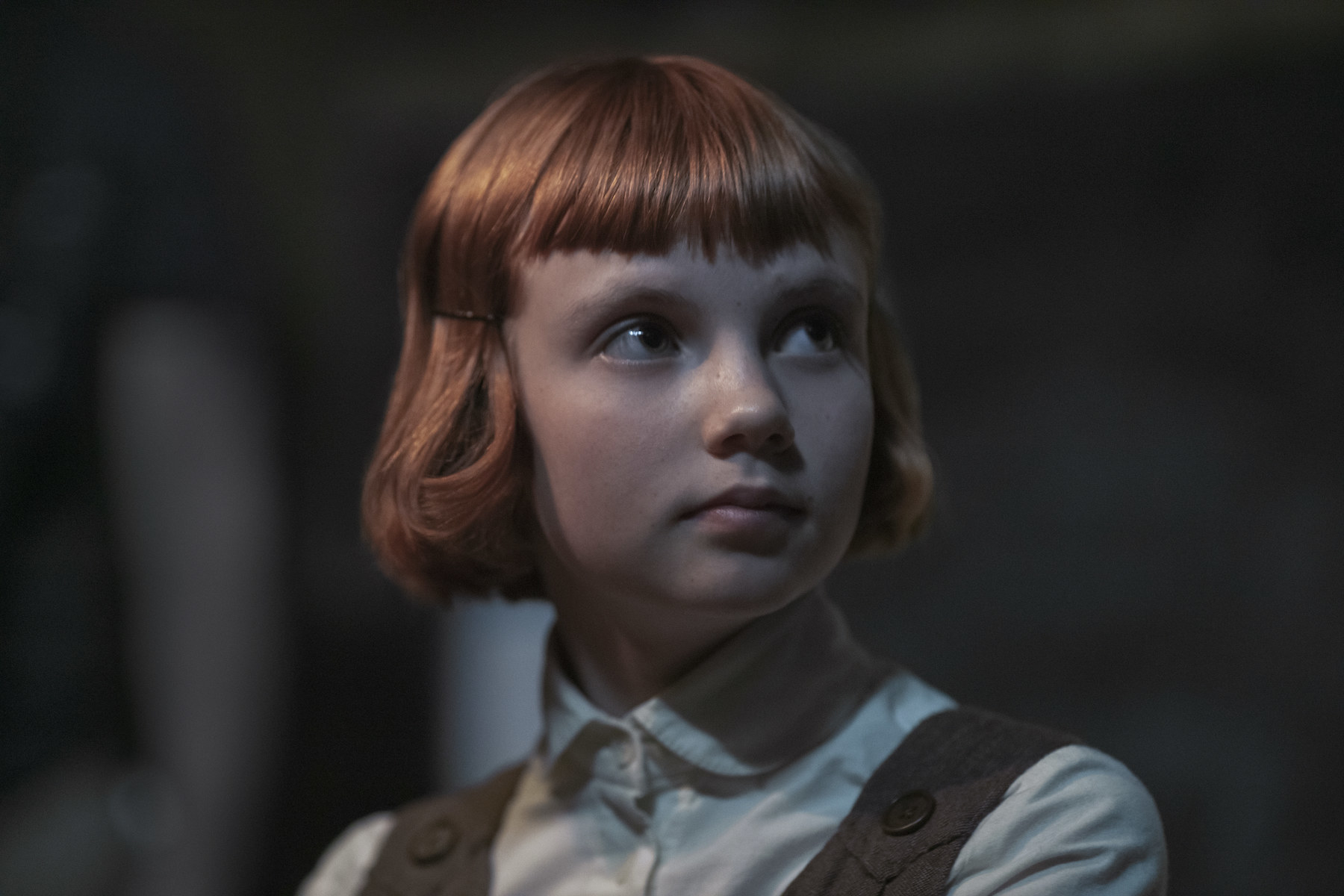 Orphaned young Beth Harmon (Isla Johnston) stares into the distance.