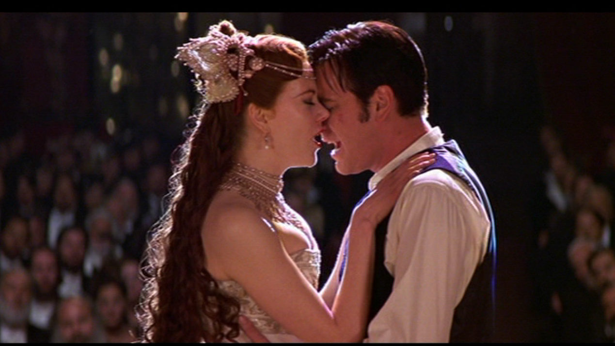 Satine and Christian embrace.