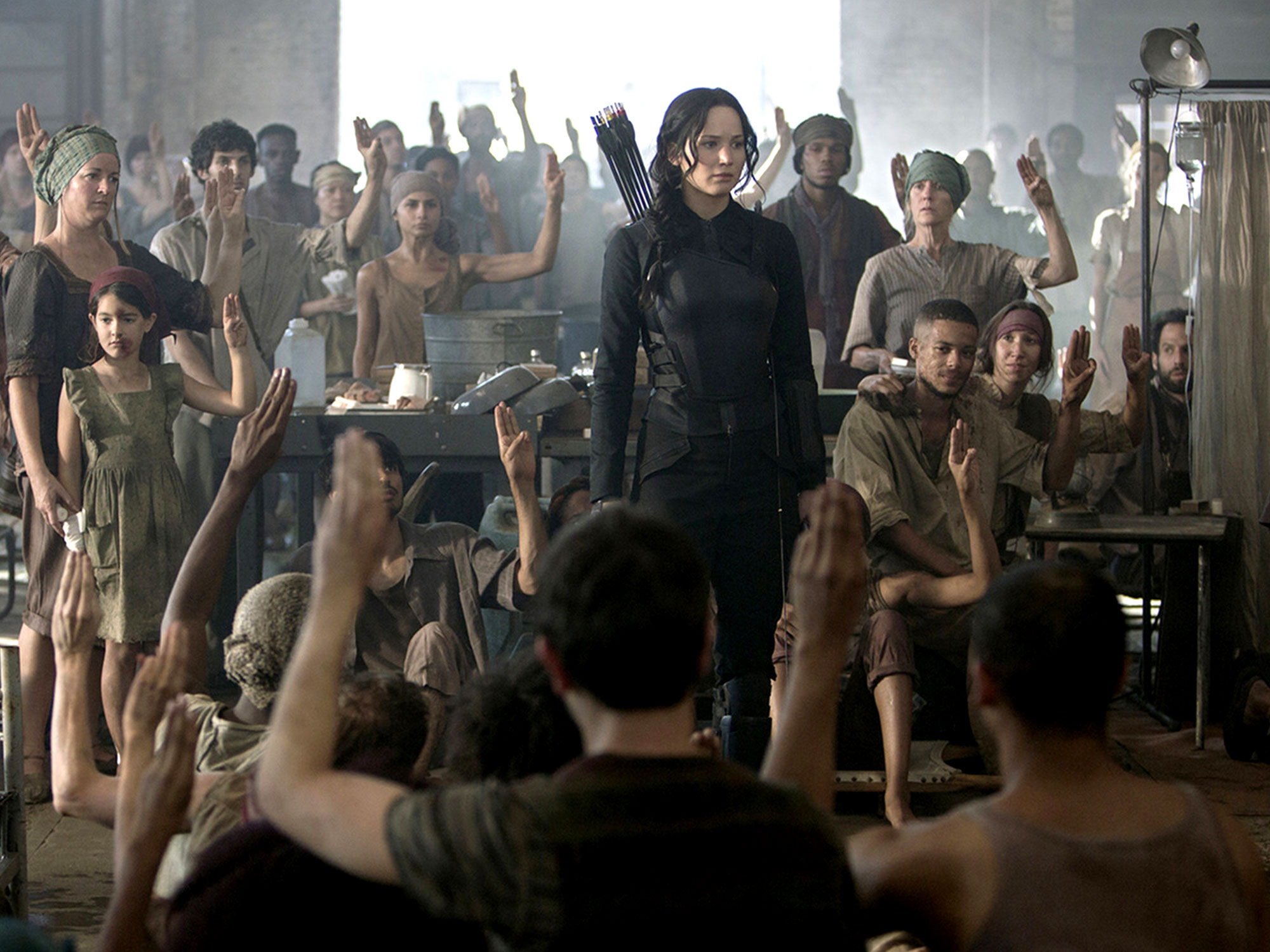 Katniss visits the hospital in Catching Fire, and is saluted by sympathizers in a poorer district within her dystopian society.