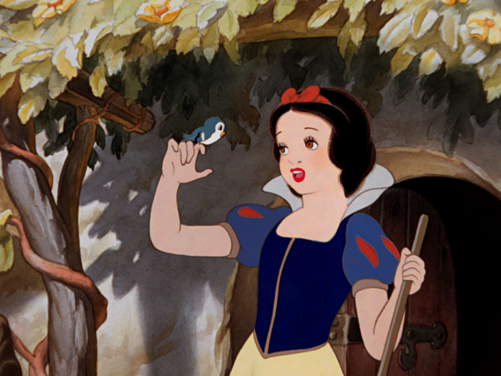 Snow White stands near a tree with a bird perched on her finger.
