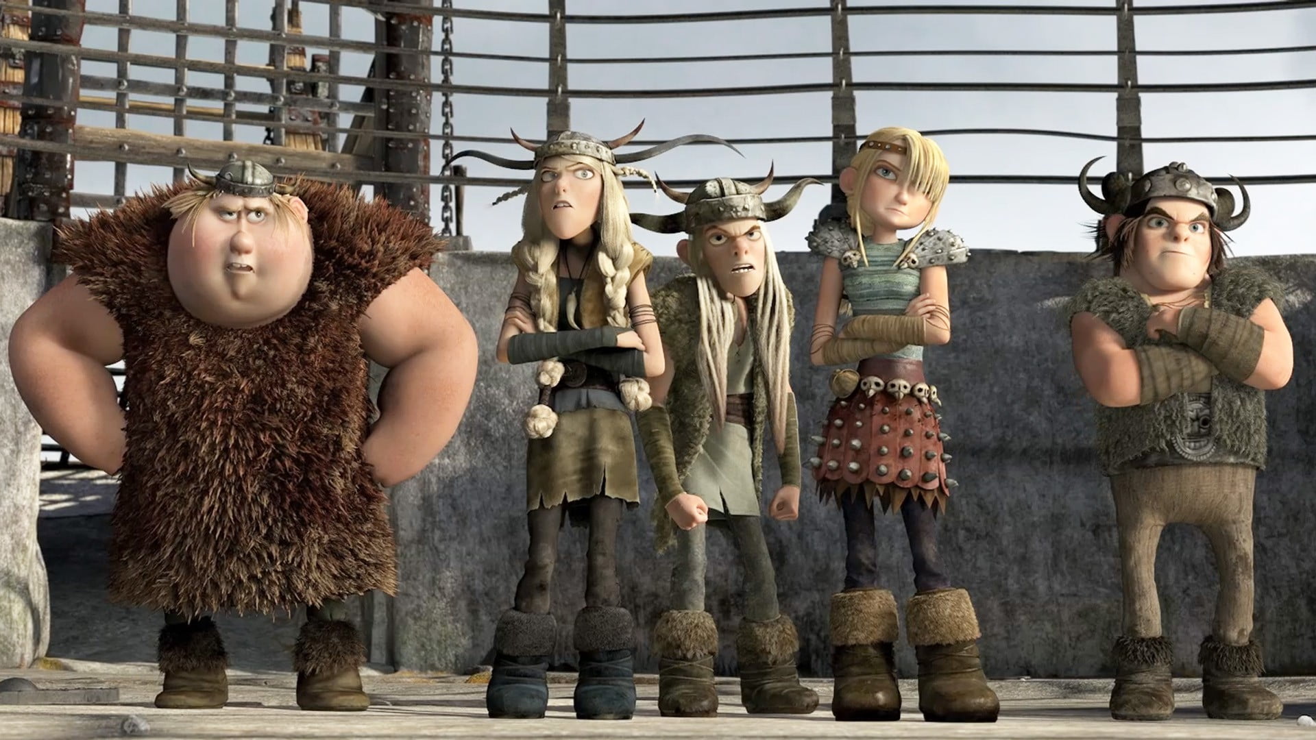 The young Vikings stand with arms crossed as Hiccup tries to tame a dragon.