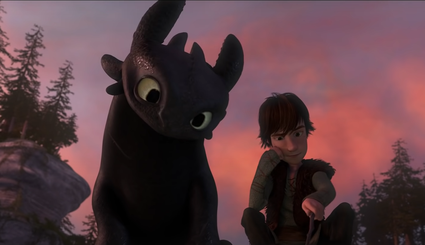 Toothless watches intently as Hiccup draws a portrait of him.