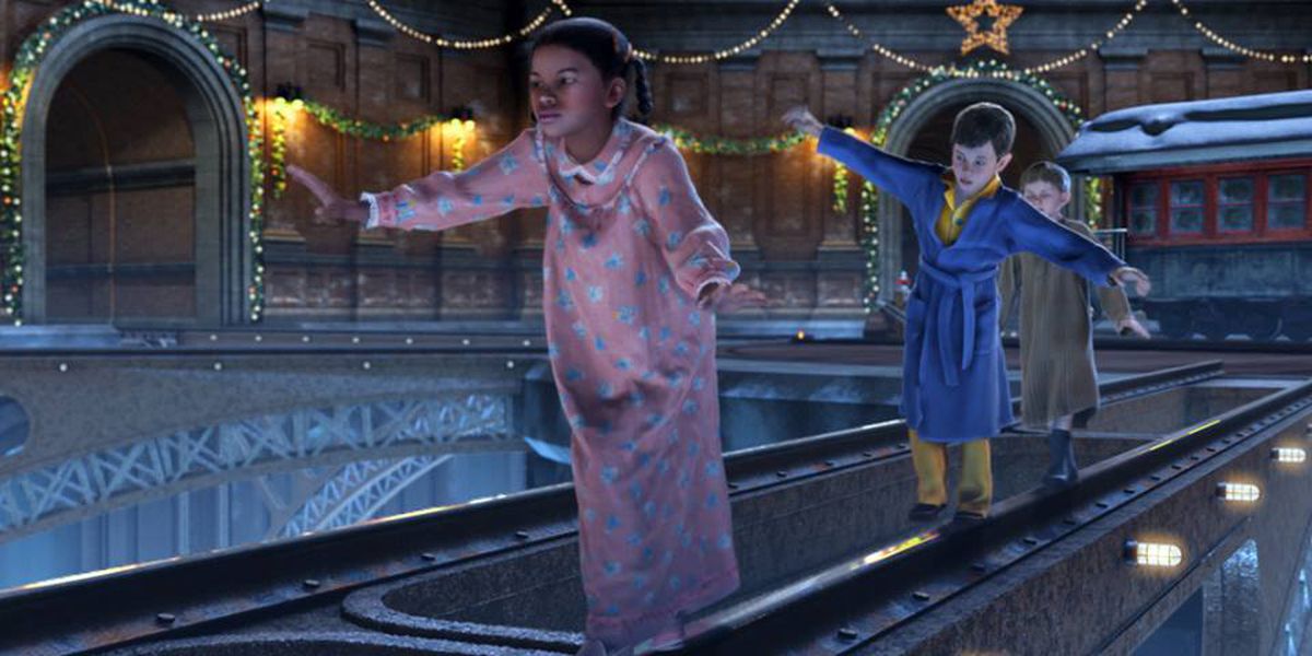 Three characters from the film walk in a line, balancing as they walk across the train tracks.