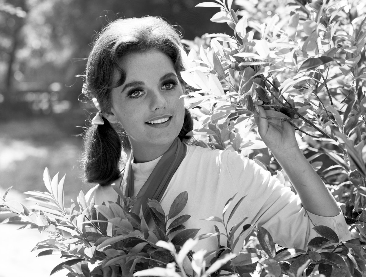 Dawn Wells poses amidst leaves. (Photo by Getty Images)