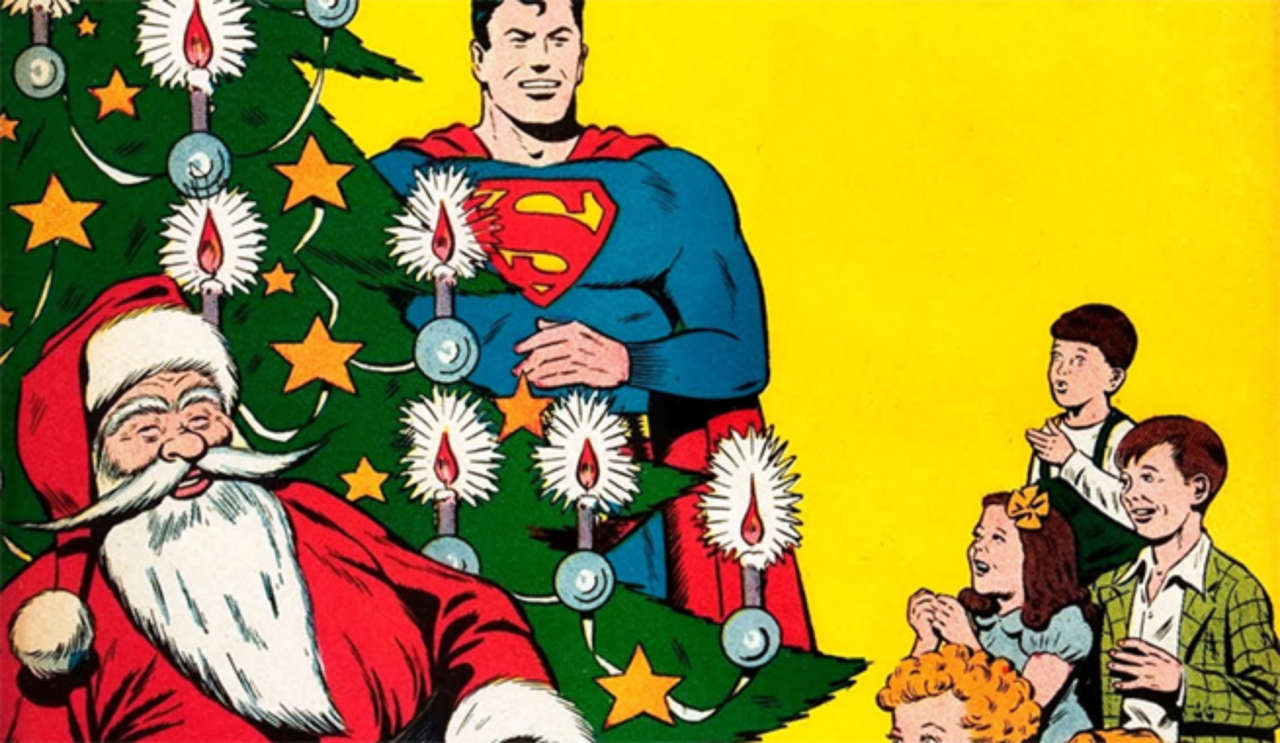 Santa Claus sits in front of a Christmas tree and Superman just behind it. Young children look on joyfully. 