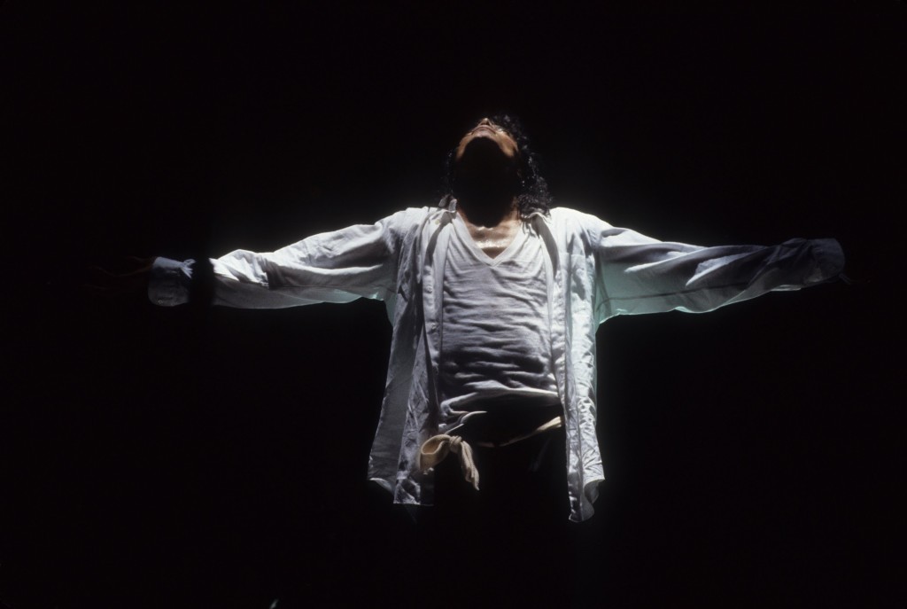 Michael Jackson looking up and holding his arms out.