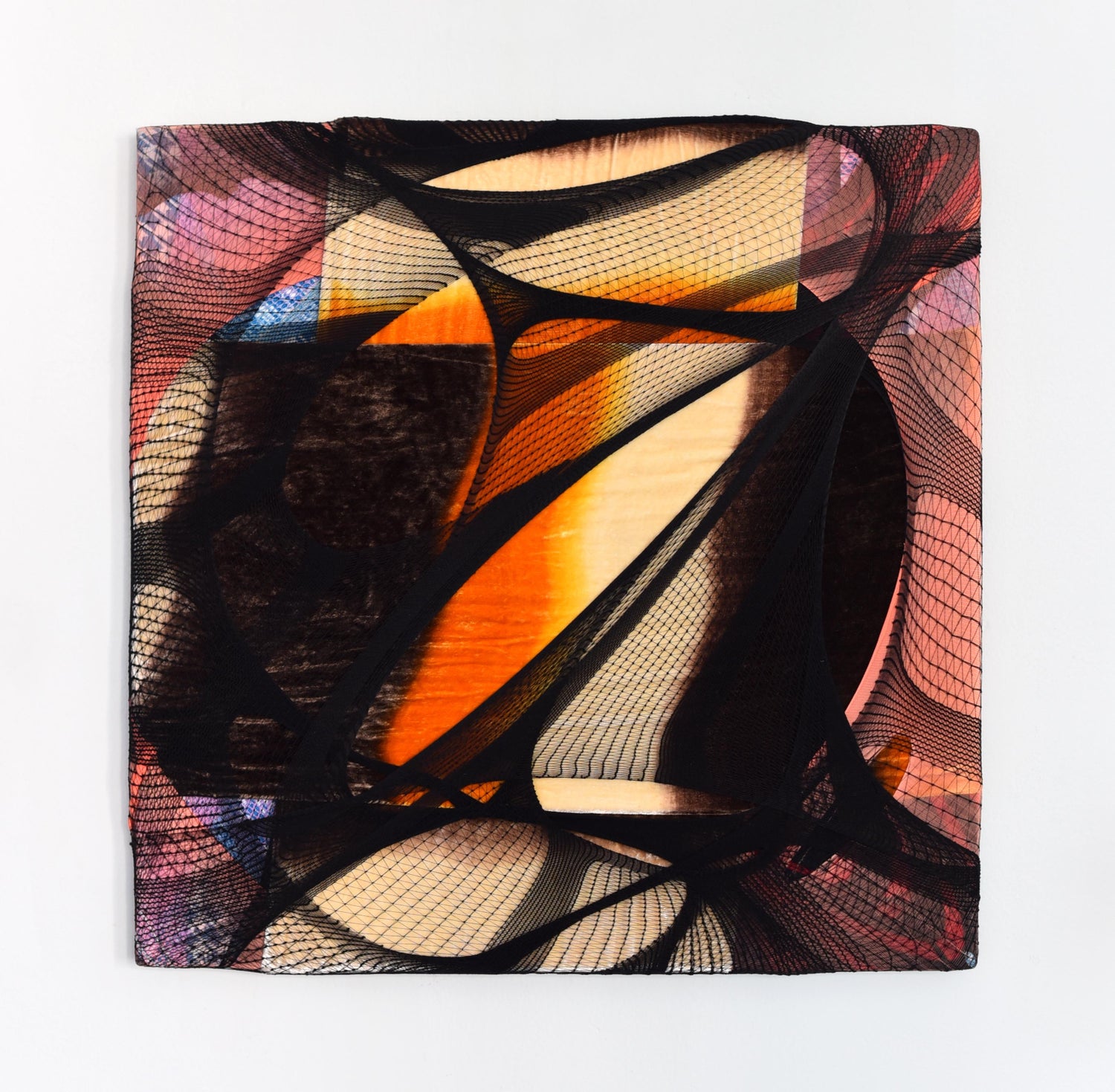 An abstract nylon, textile piece with the nylon in colors of orange and black, stretched across a canvas. 