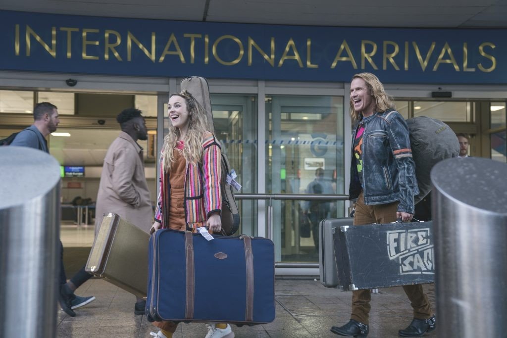 Sigrit and Lars walk with suitcases at the airport in David Dobkin's comedy 'Eurovision Song Contest: The Story of Fire Saga', 2020. (Photo by Netflix)