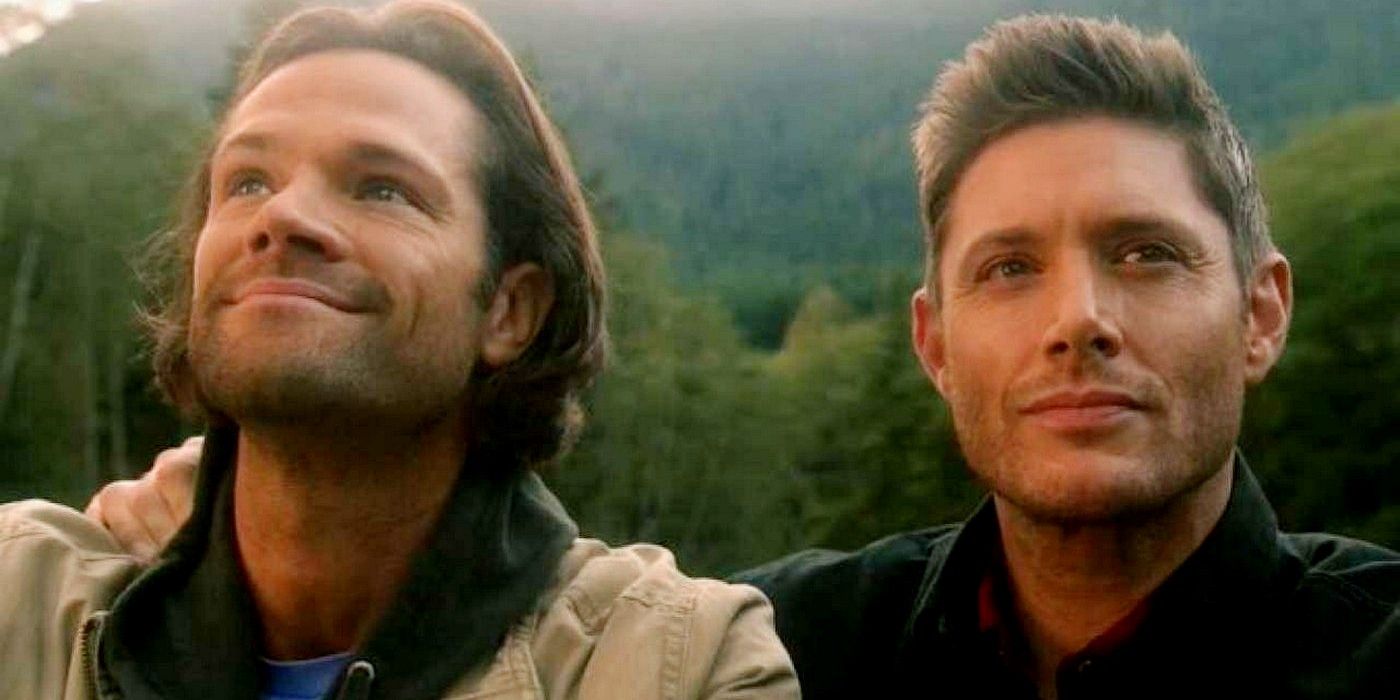 A close up shot of Sam and Dean. Sam is on the left, and is looking up at the sky while smiling. Dean is on the right, and is looking ahead and slightly to the right, into the middle-distance. He is smiling slightly.