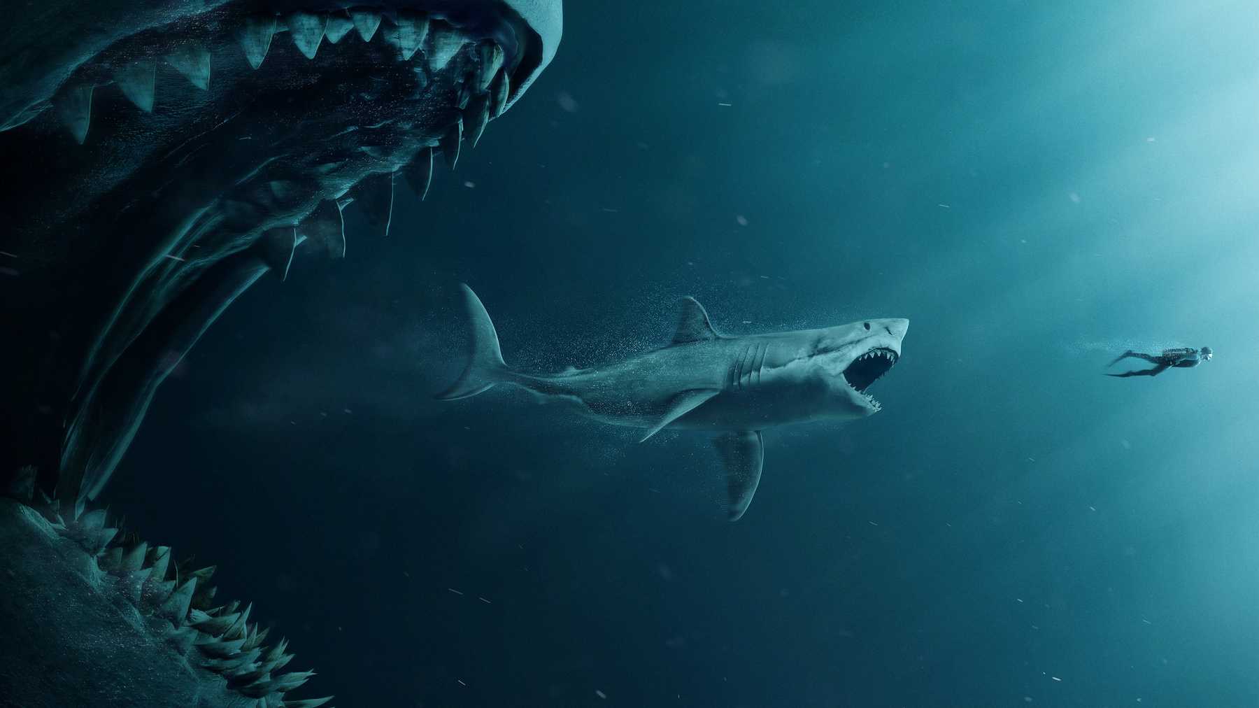 The megalodon about to eat the great white shark that is about to eat the human, showing the size difference between the animals. This is a movie poster for The Meg.