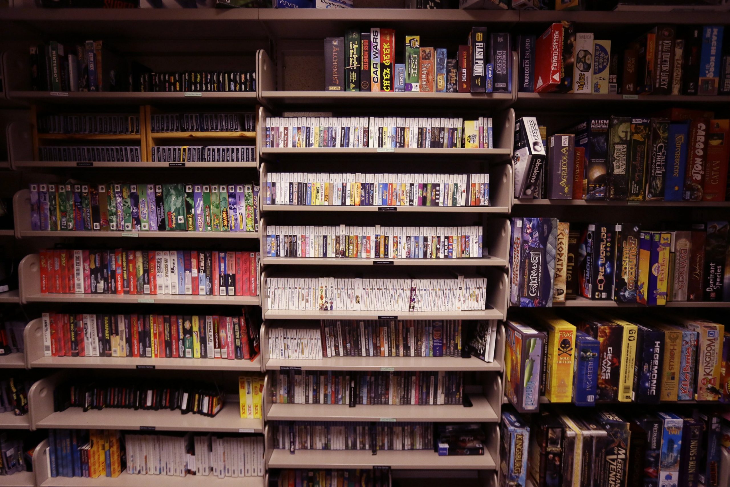 A shelf full of various video games. 