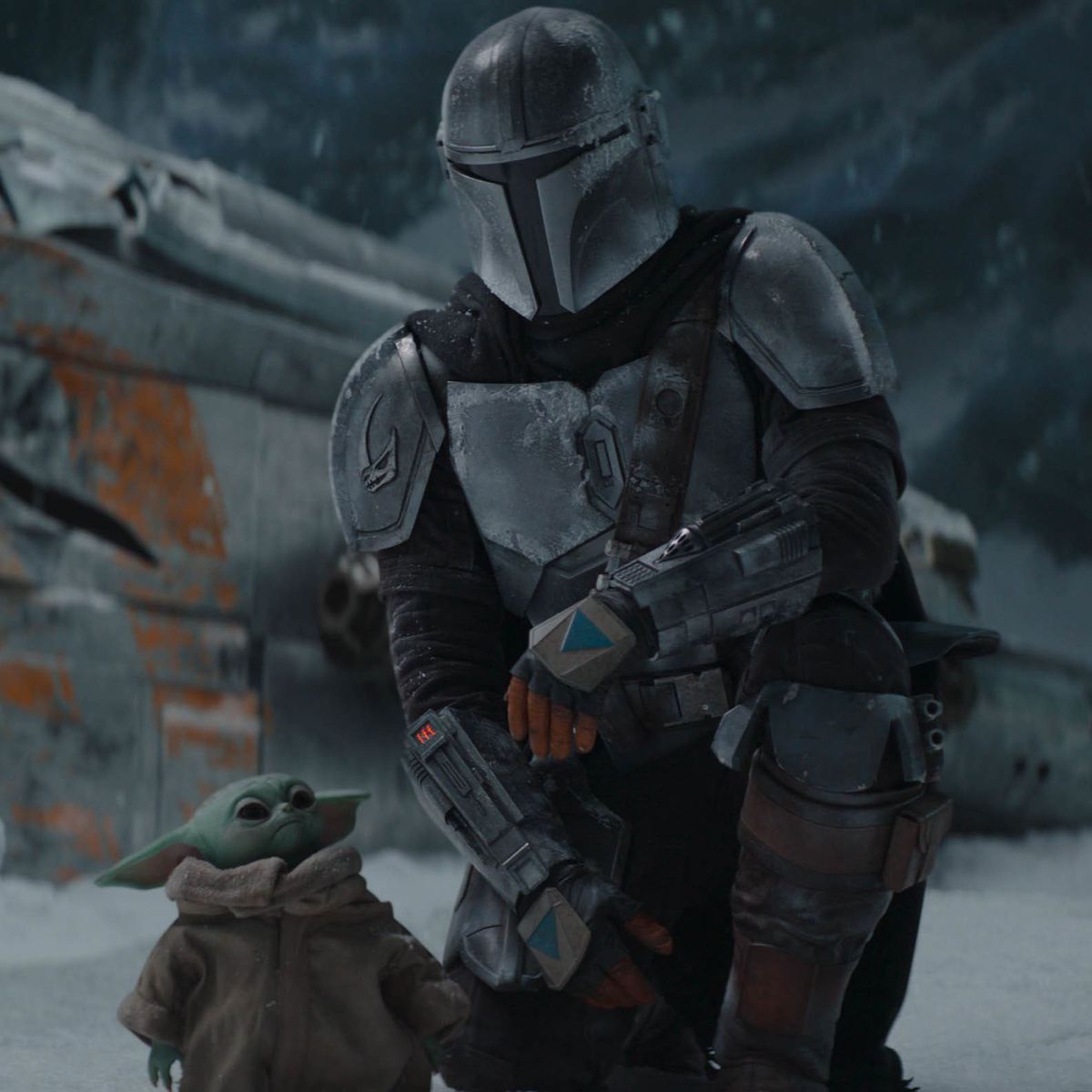 The Mandalorian takes a knee beside Grogu and contemplates the damage to his ship.