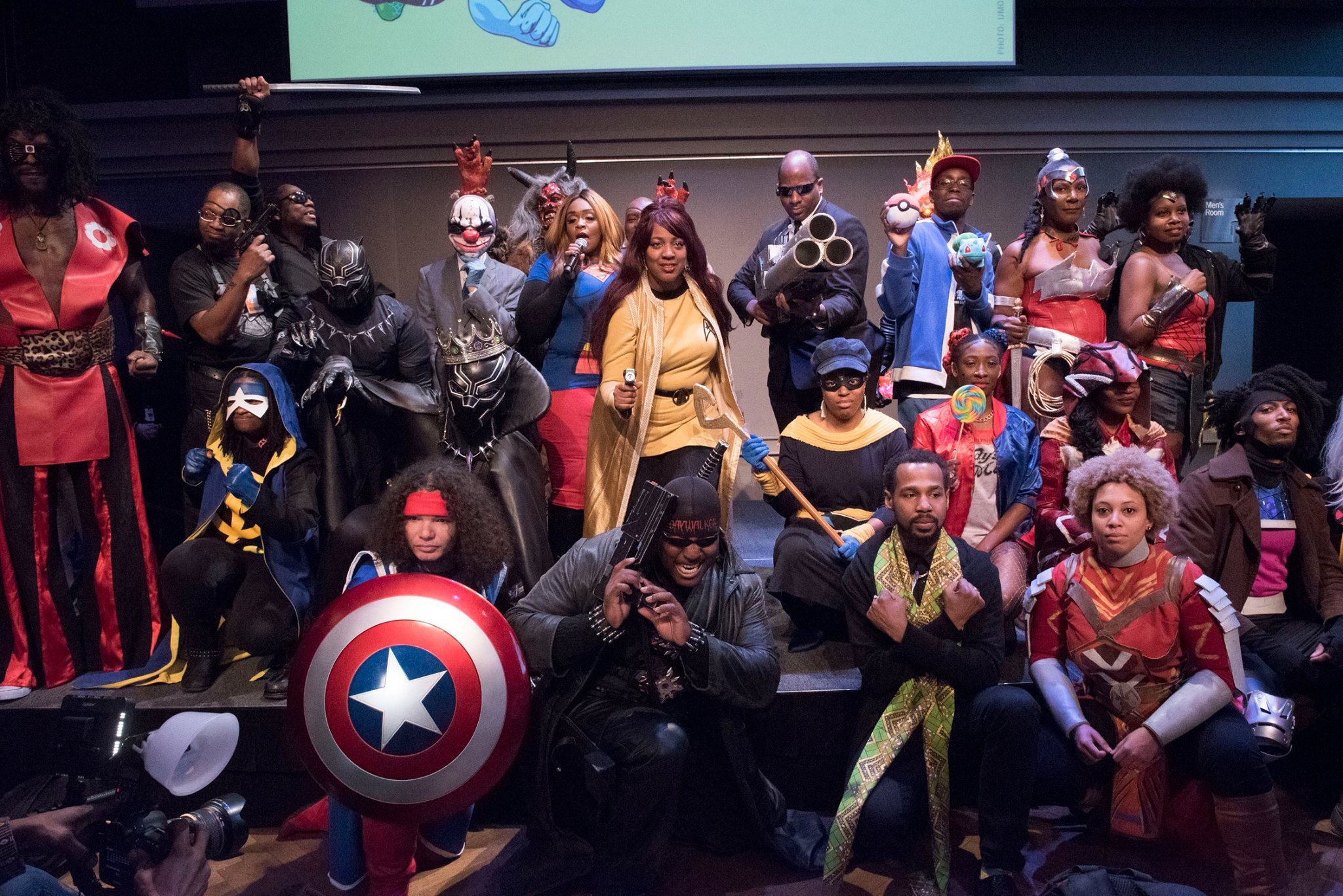 A group of Black cosplayers pose together for a group photo.