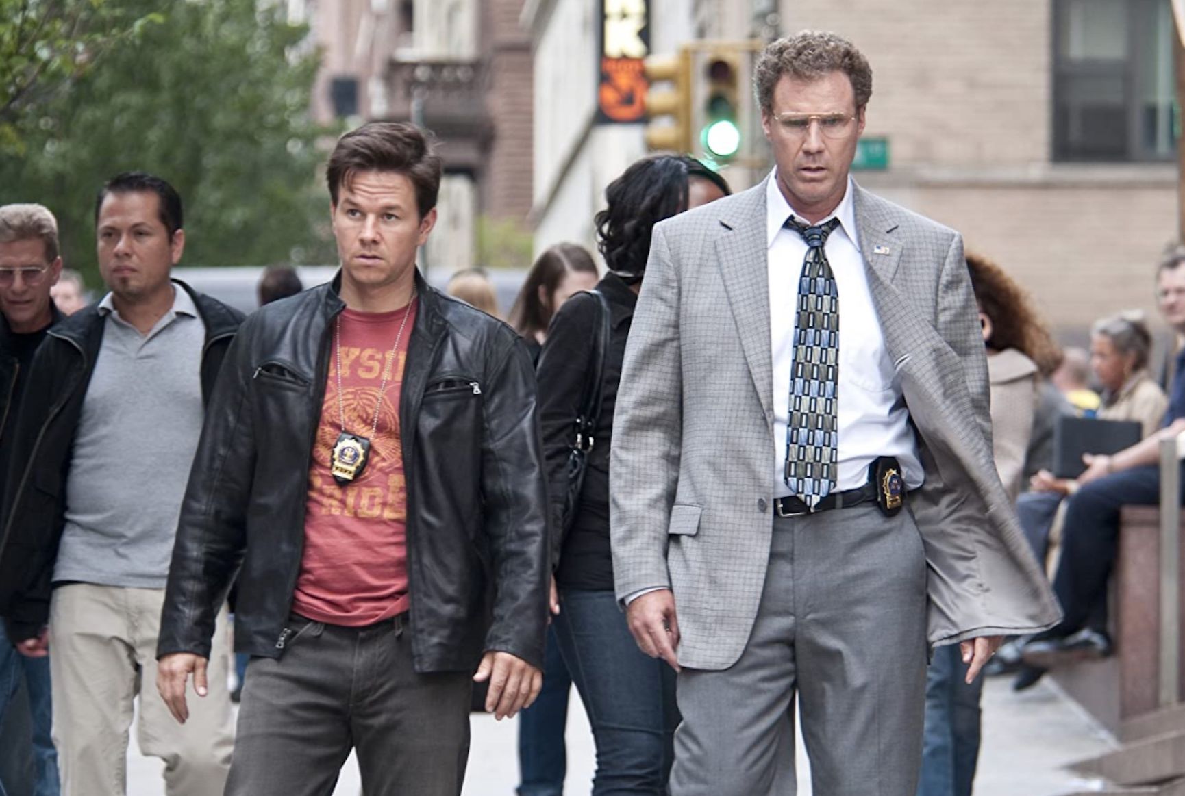 Mark Wahlberg (left) and Will Ferrell (right) walk down a busy street in The Other Guys.