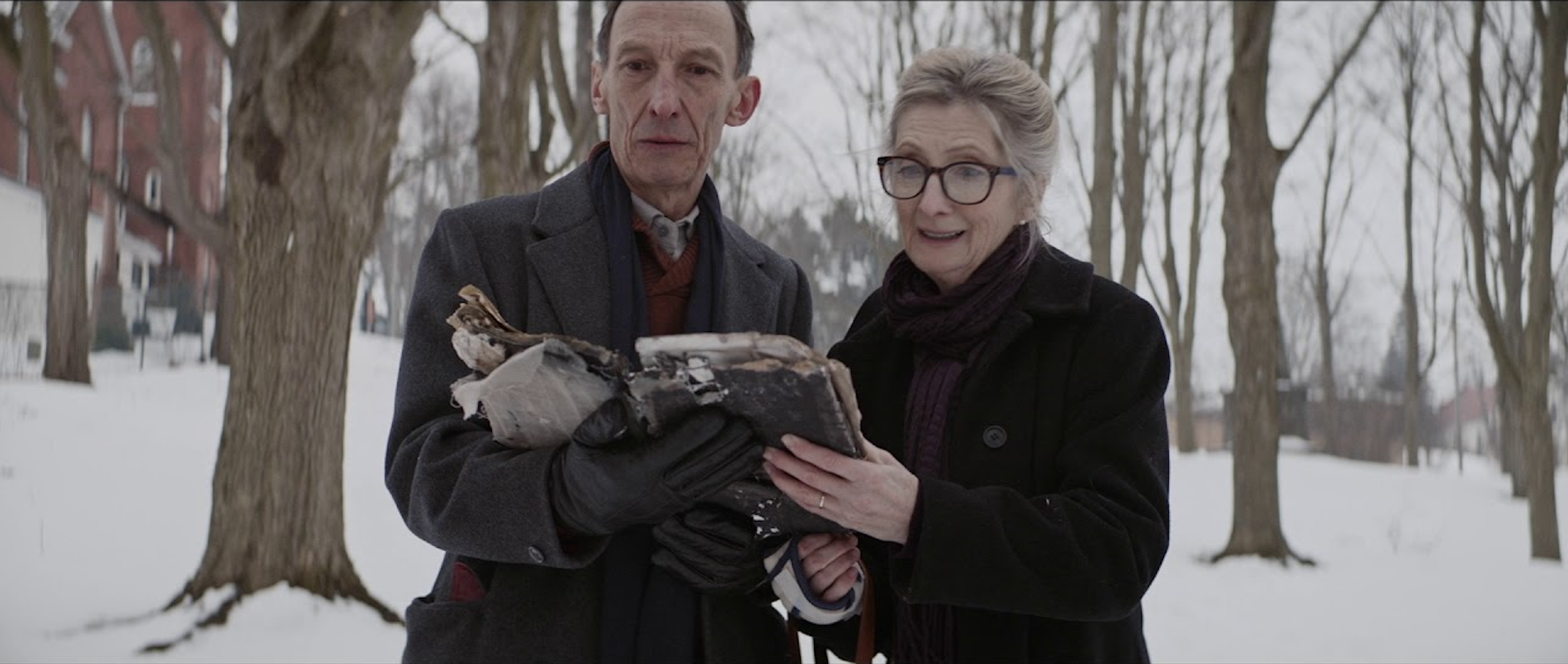 Grandparents [Julian Richings & Sheila McCarthy] reading from occult book. Photo credit: Dyck, Justin. dir. Anything For Jackson. 2020.