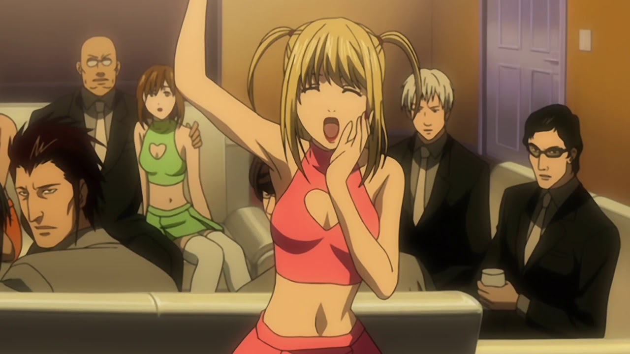 Misa from Death Note being bubbly as usual, but isn't as dense as most of the men in the room think she is. 