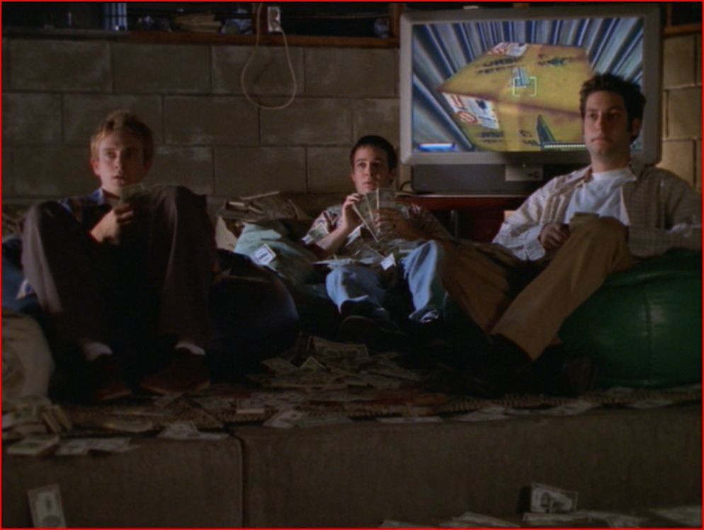 Andrew, Jonathan, and Warren sit in beanbag chairs in their lair in a shot from Buffy the Vampire Slayer, 1997-2003 (Photo by Mutant Enemy Productions/20th Century Fox).