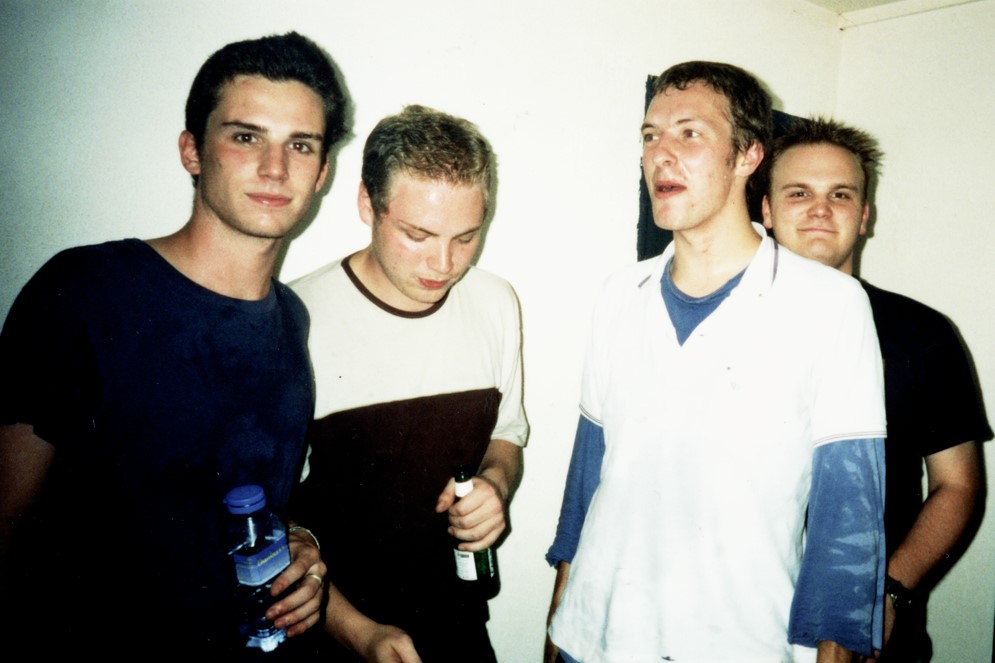 The members of Coldplay as they are just becoming a band: Guy Berryman, Jonny Buckland, Chris Martin, and Will Champion.