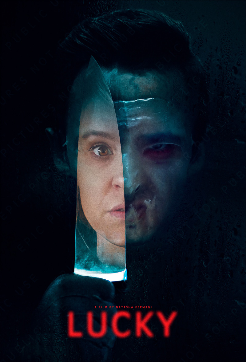 Movie poster for Lucky. Brea Grant's reflection shown in a knife held by her masked stalker.