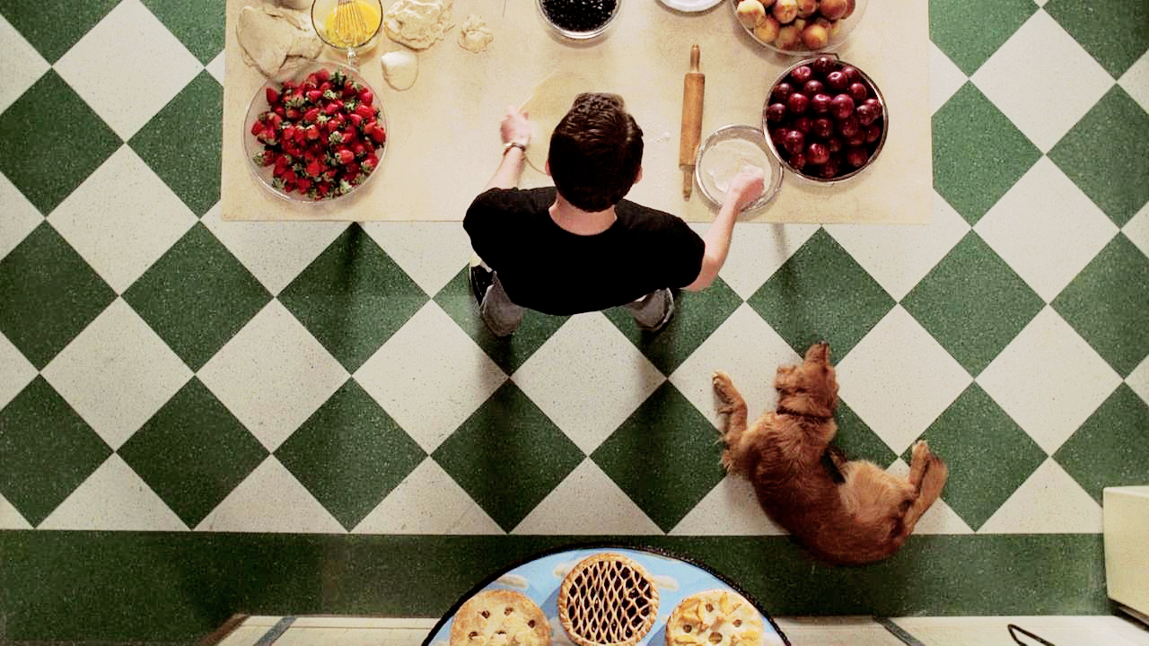 An overhead shot of Ned (Lee Pace) and Digby (Orbit and Orion) together in the kitchen.

Pushing Daisies. Season 1, Episode 1: "Pie-Lette." 2007-2009. ABC.