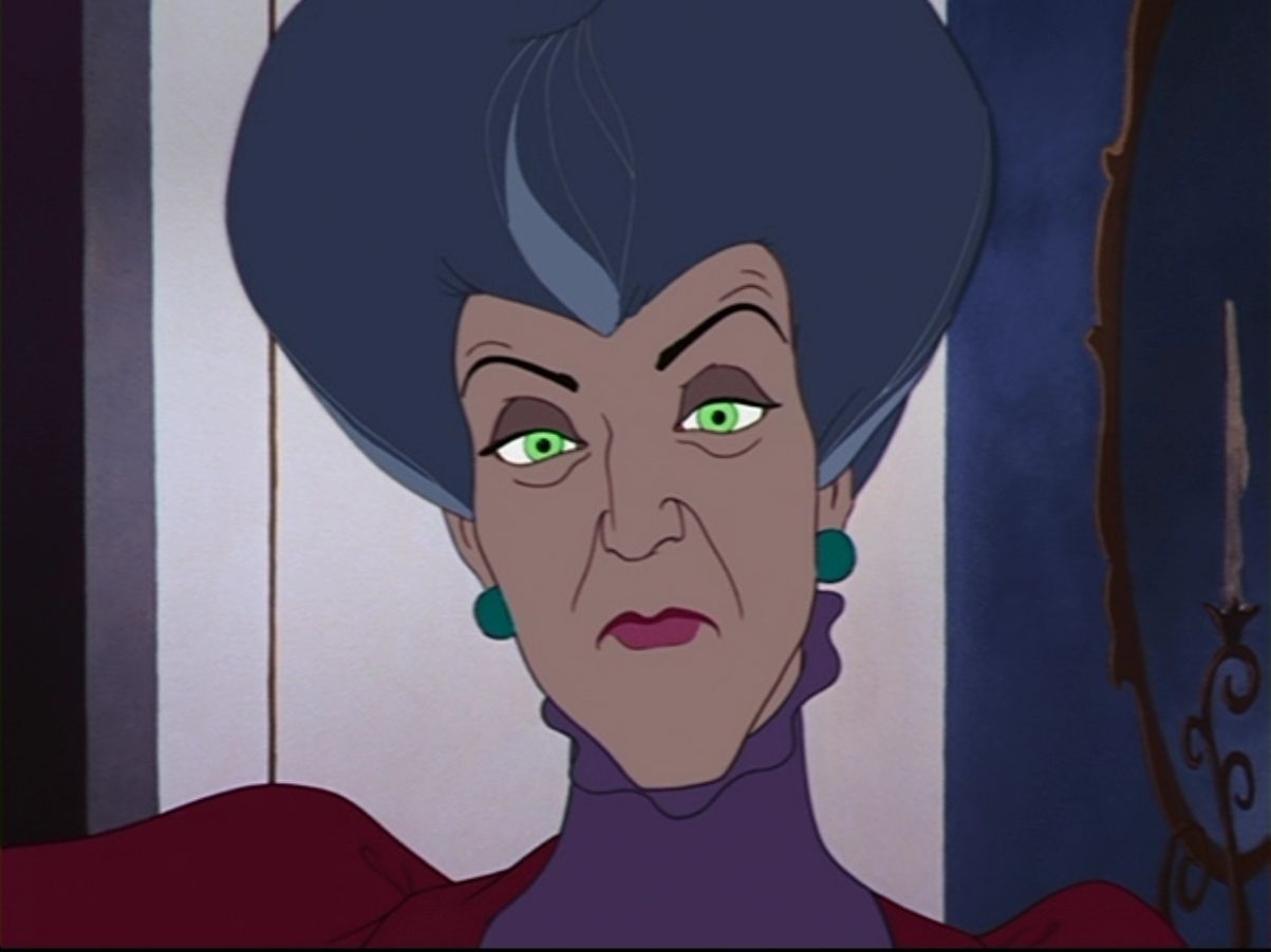 Lady Tremaine, Disney's Cinderella's Evil Stepmother, is staring straight ahead with menacing, glowing green eyes.