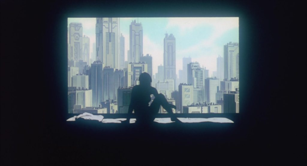 Ghost In The Shell. Mamoru Oshii. 1995. (This is a picture from the film Ghost In The Shell. A woman in front of a window, looking out at the city.)