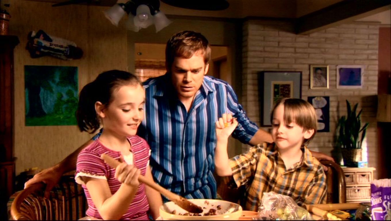 Season one, and features Dexter Morgan and his step kids (Astor and Cody Bennett.) He's helping them bake while they're mother is working.