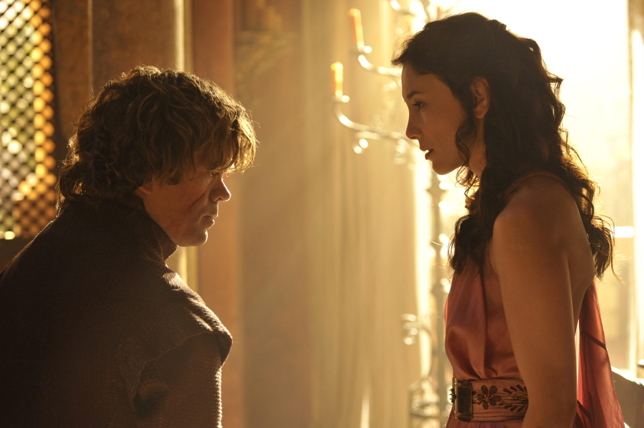 Tyrion and Shae stand together in their bedroom, looking at one another.