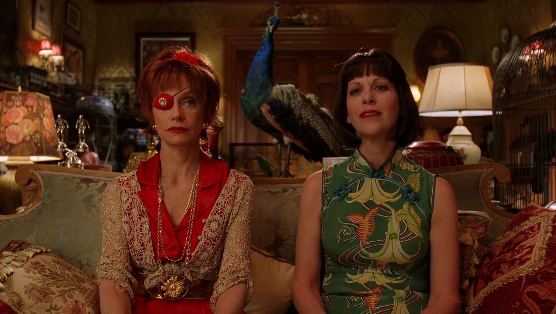 Lily (Swoosie Kurtz) and Vivian (Ellen Greene) are pictured sitting on the couch of their eccentric home. A peacock sits behind them. 

Pushing Daisies. Season 1, Episode 1: "Pie-Lette." 2007-2009. ABC.