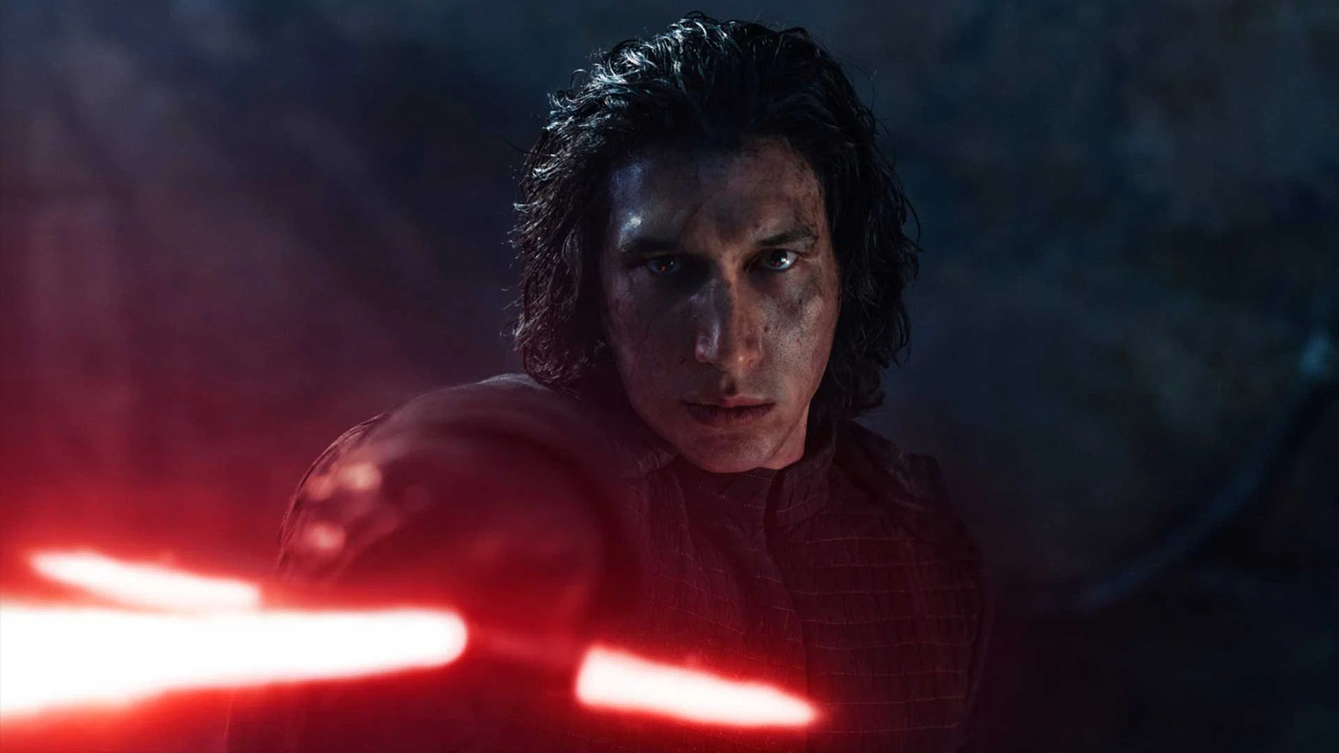 Kylo Ren stands at the ready with his lightsaber drawn.